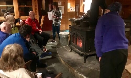 Around the stove for a presentation by the staff