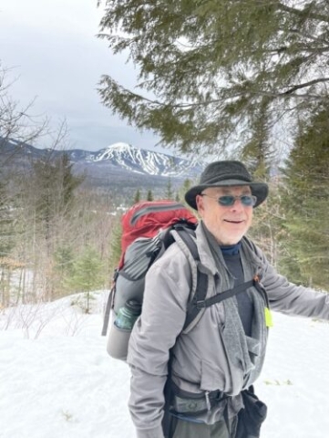 Larry with Sugarloaf downhill runs in the background on the way to Stratton Brook Hut