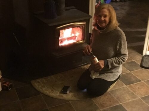 Shae stokes the fire in the Lapin Tupa living room...cozy