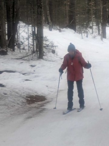 Althea skiing near a "brown" spot in the trail